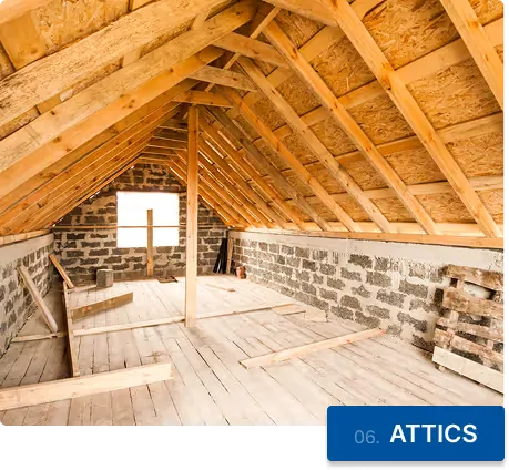 An empty attic under exposed roof rafters