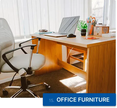 A wooden desk and an office chair ready to be removed
