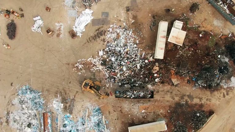 Sorted waste spread across a transfer yard, seen from above